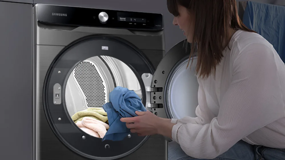 Woman Checking the Dryer Load