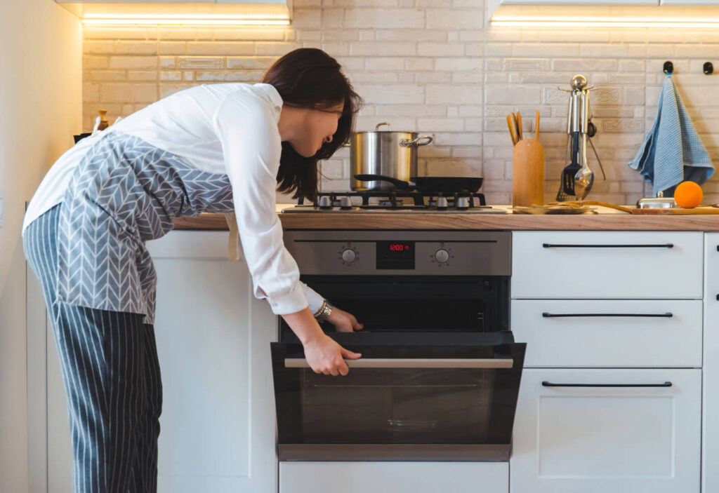 woman opening an oven