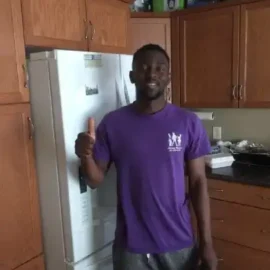 Happy fridge repair client with thumbs up